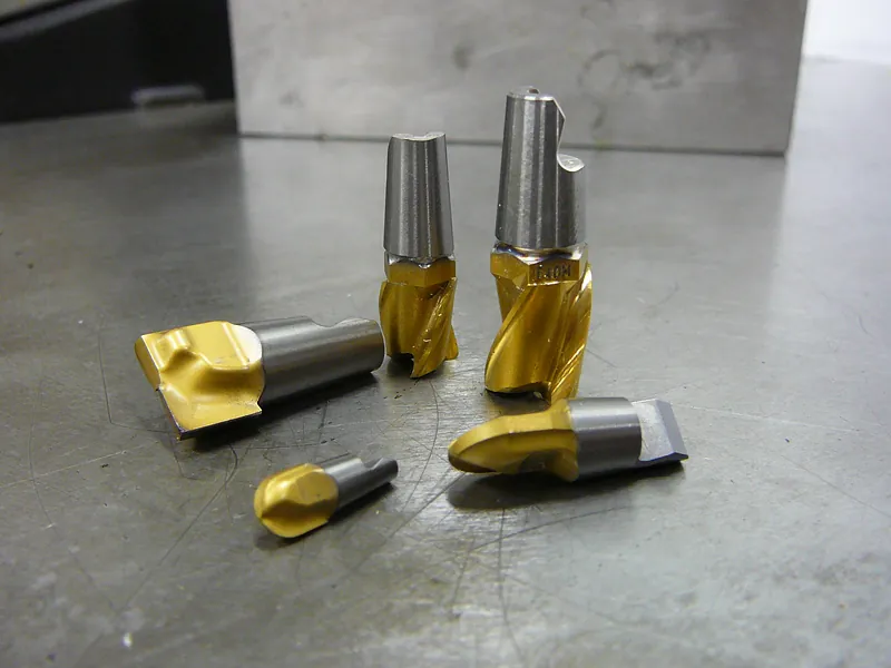 Coated milling cutters and countersinks on a steel table
